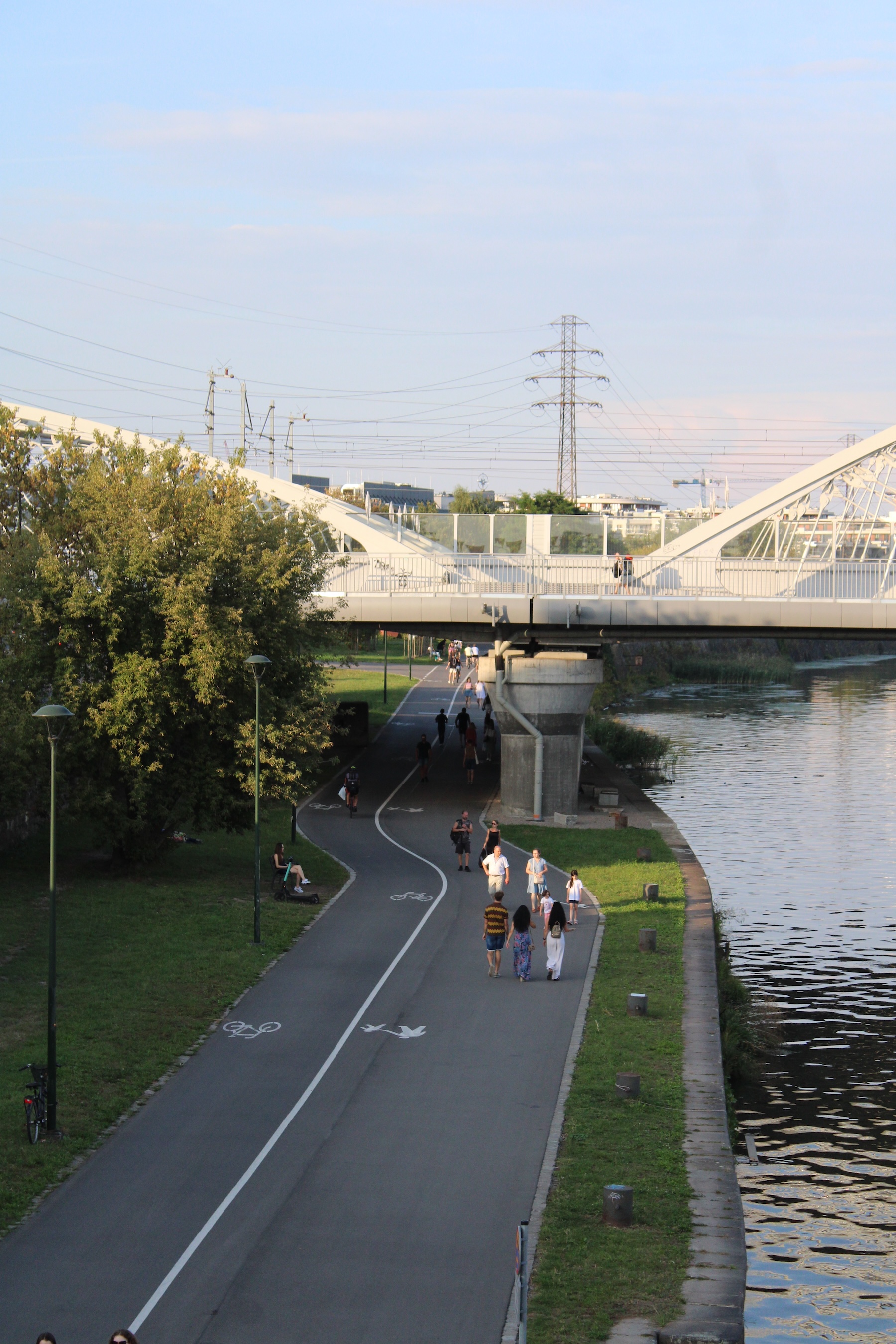 A walking and biking pathway that follows the river. There's a bridge over both.